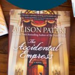 A copy of the book The Accidental Empress sits on the table.