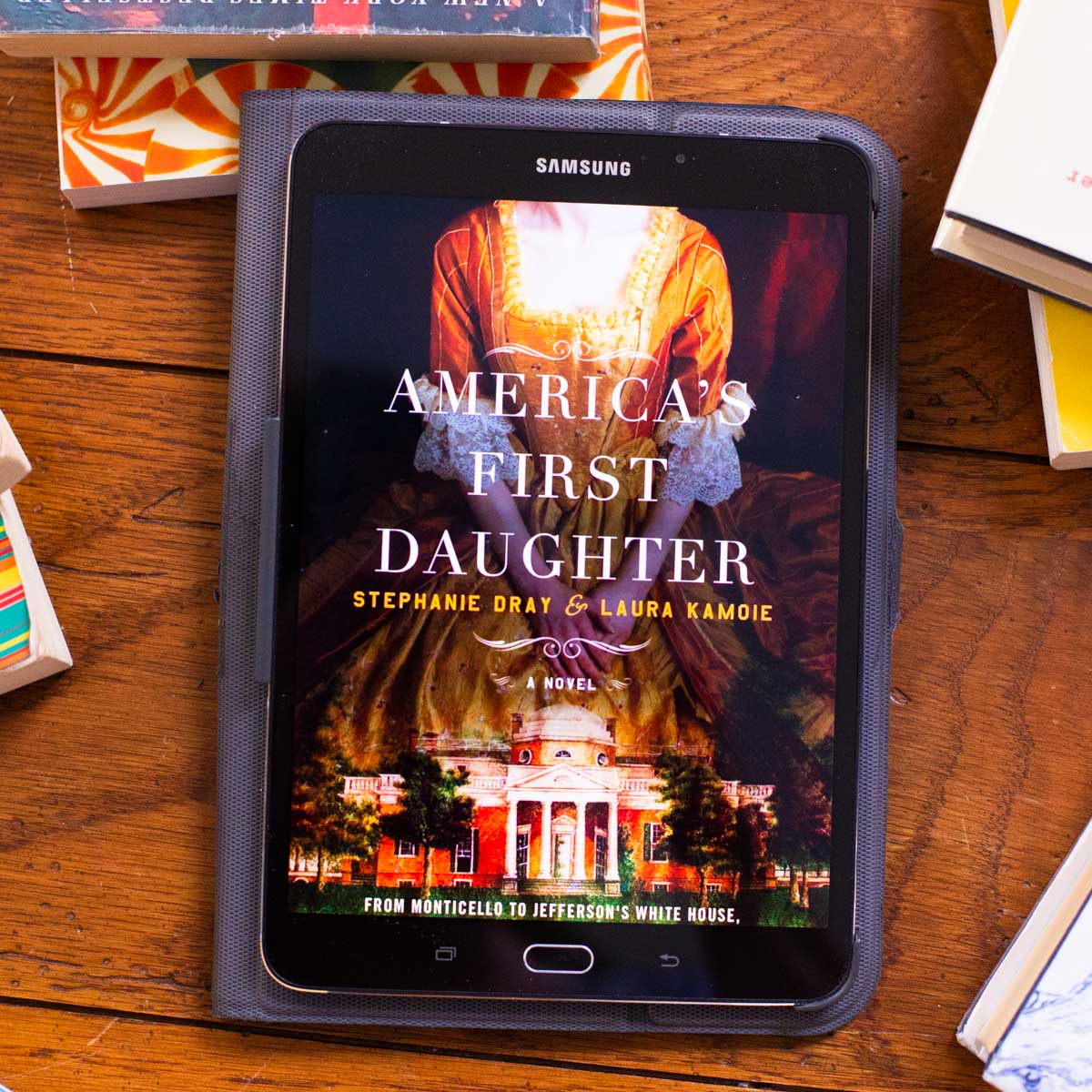 A reading tablet has the cover of America's First Daughter on the screen.