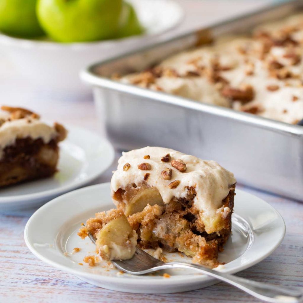 A slice of apple cake shows the fresh apple slices in side.