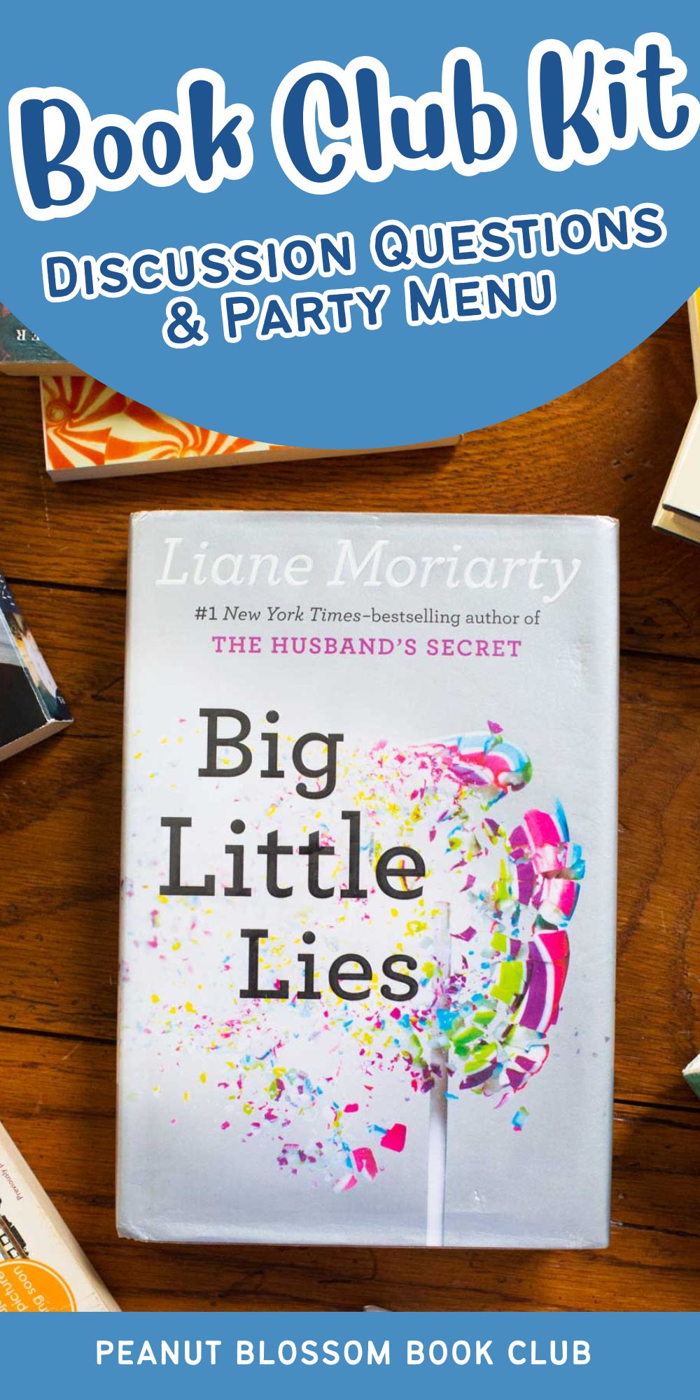 A copy of Big Little Lies is on a table surrounded by other books.