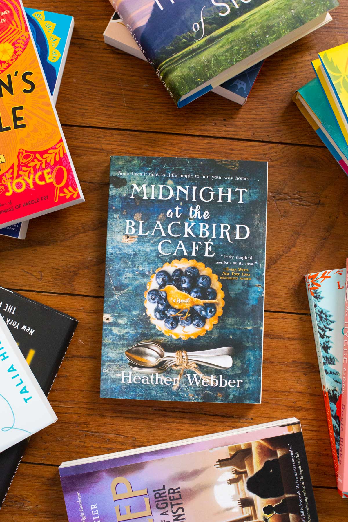 A copy of the book Midnight at the Blackbird Cafe is on the table.