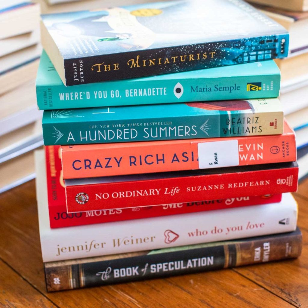 A stack of books sits on the table.