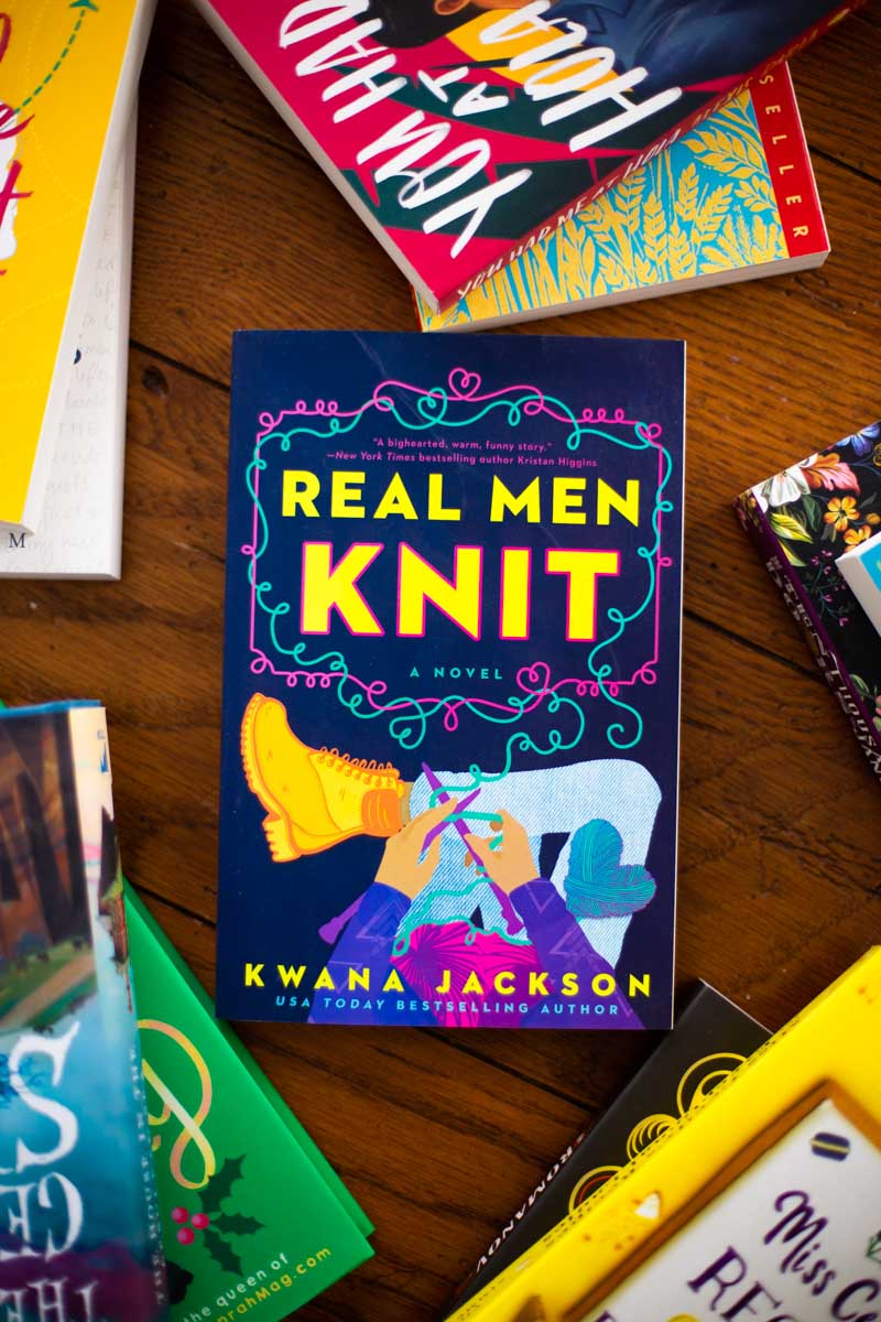 A copy of the book Real Men Knit is on the table.