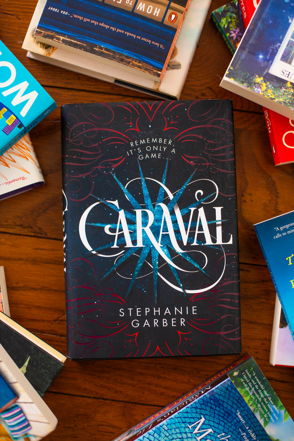 A copy of the book Caraval sits on the table.