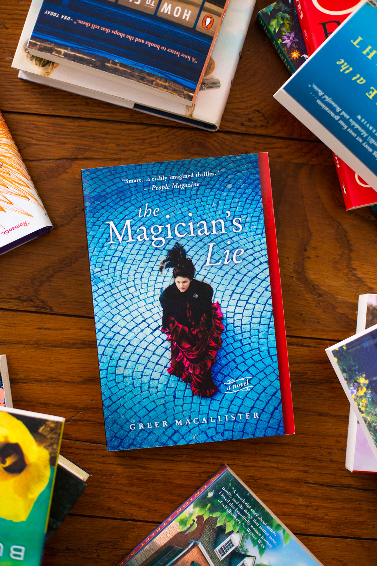 A copy of the book The Magician's Lie is on the table.