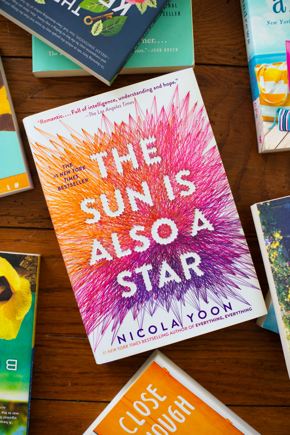 A copy of the book The Sun is Also a Star is on the table.