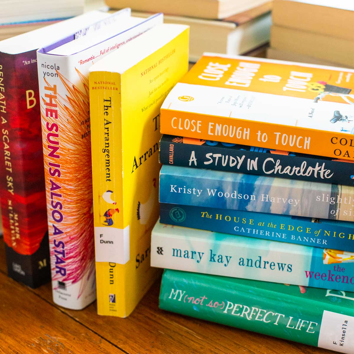 A stack of colorful books is on the table.
