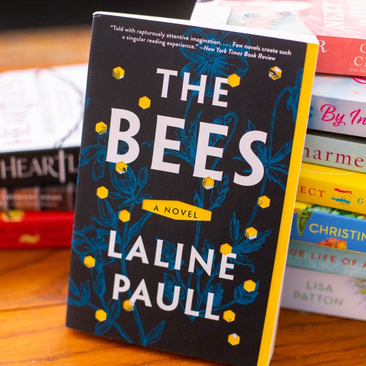 The copy of the book The Bees sits on a table.