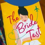 A copy of the book The Bride Test sits on a stack of books.