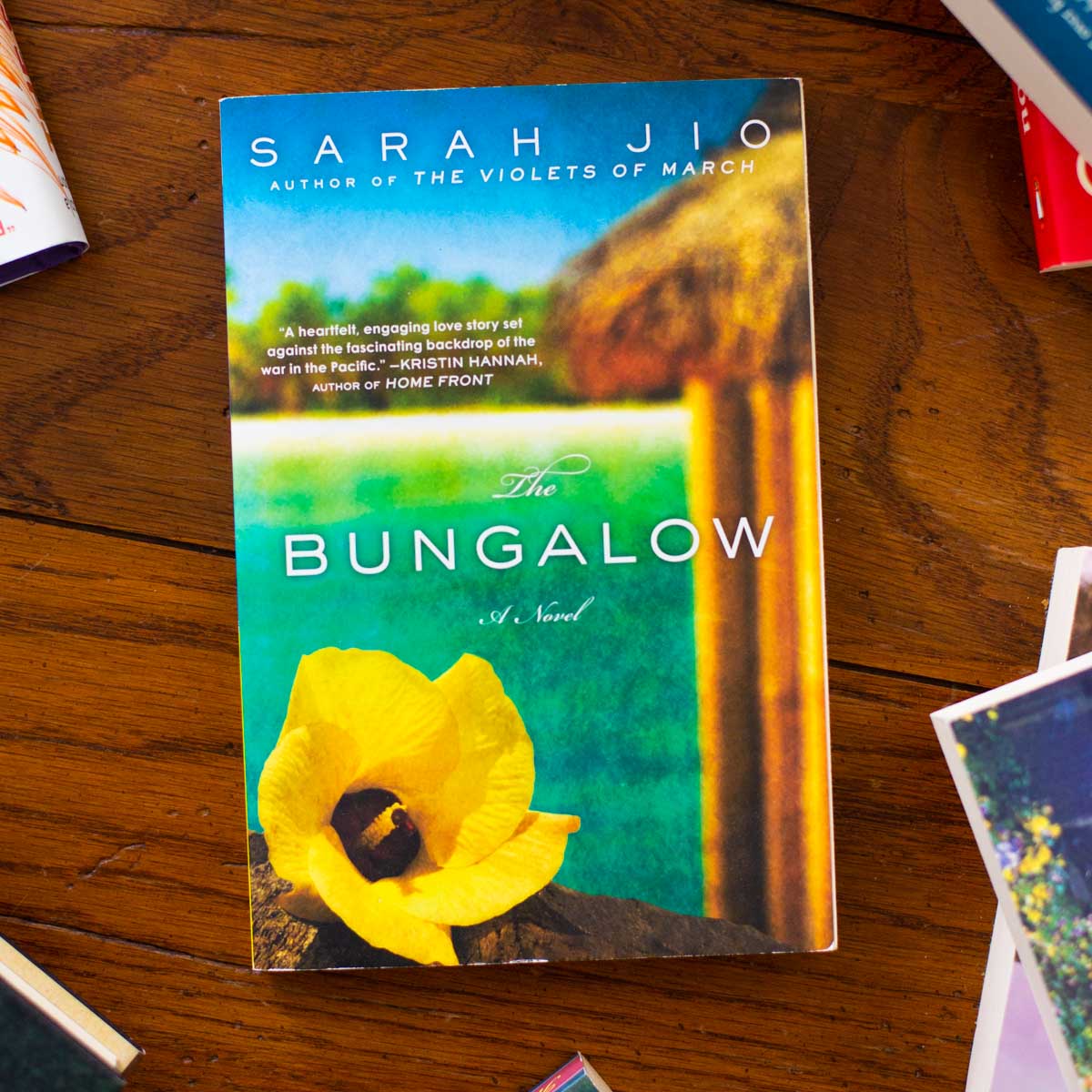 A copy of the book The Bungalow sits on a table.