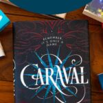 A copy of the book Caraval sits on the table.