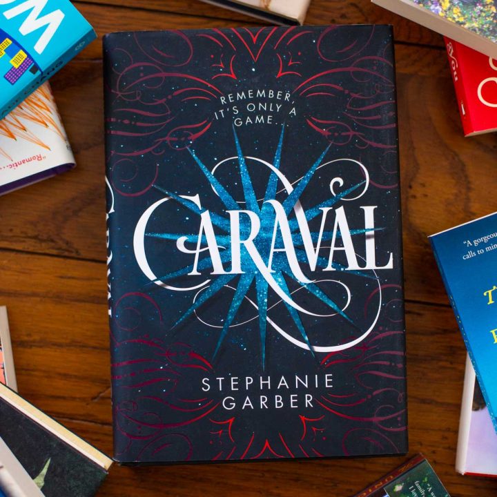 A copy of the book Caraval sits on the table.