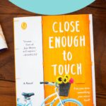 A copy of the book Close Enough to Touch is on the table.