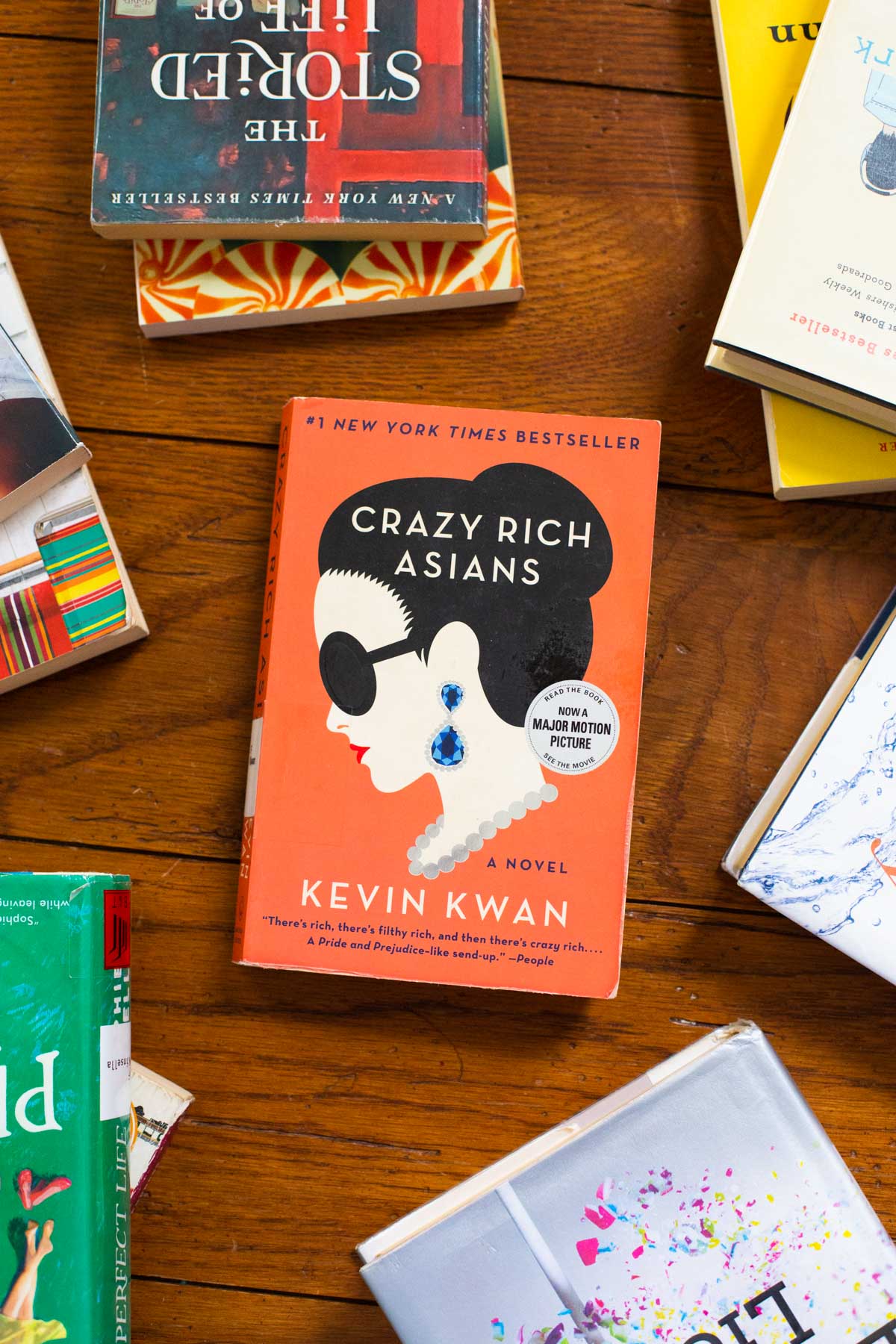 A copy of the book Crazy Rich Asians is on a table.