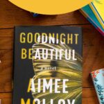 A copy of the book Goodnight Beautiful is on the table.