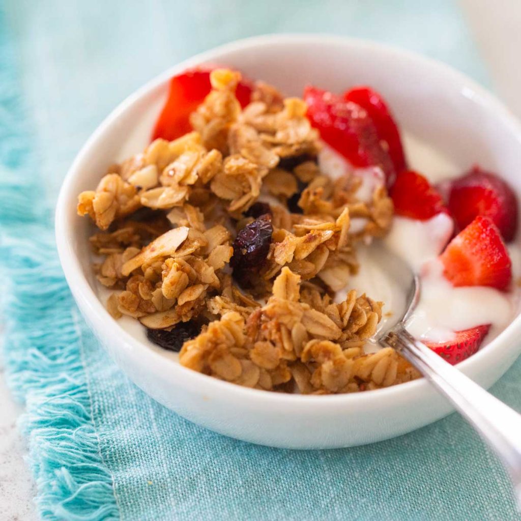 A yogurt bowl topped with homemade granola and fresh berries.