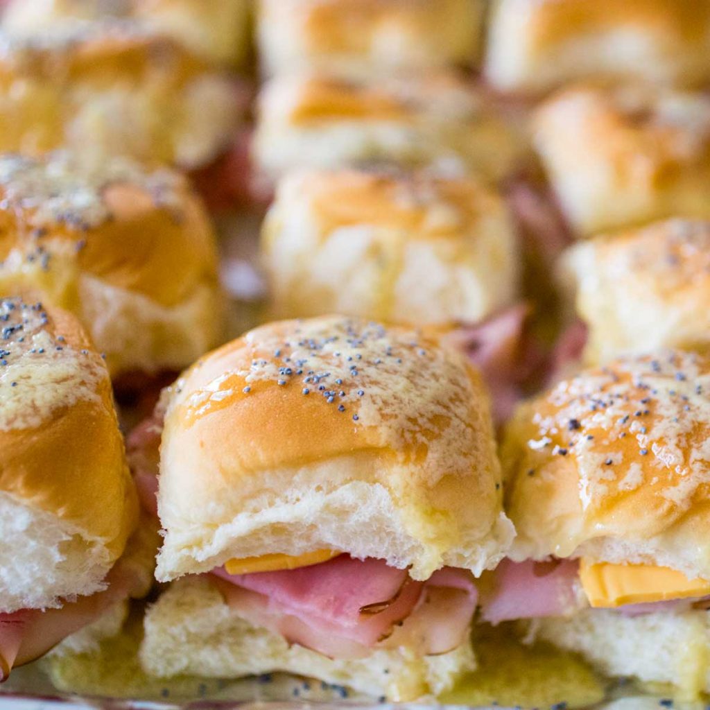 A baking pan filled with ham and cheese sliders.