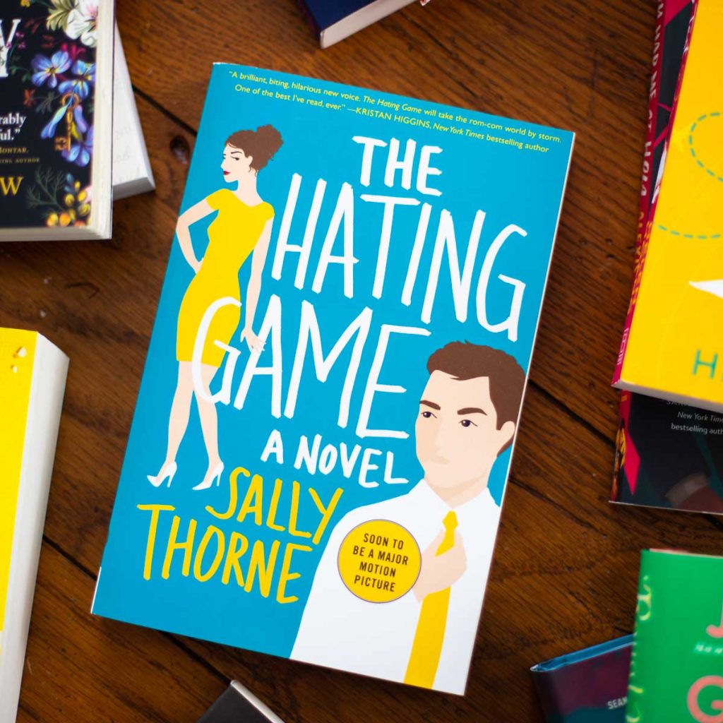 A copy of the book The Hating Game is on the table.