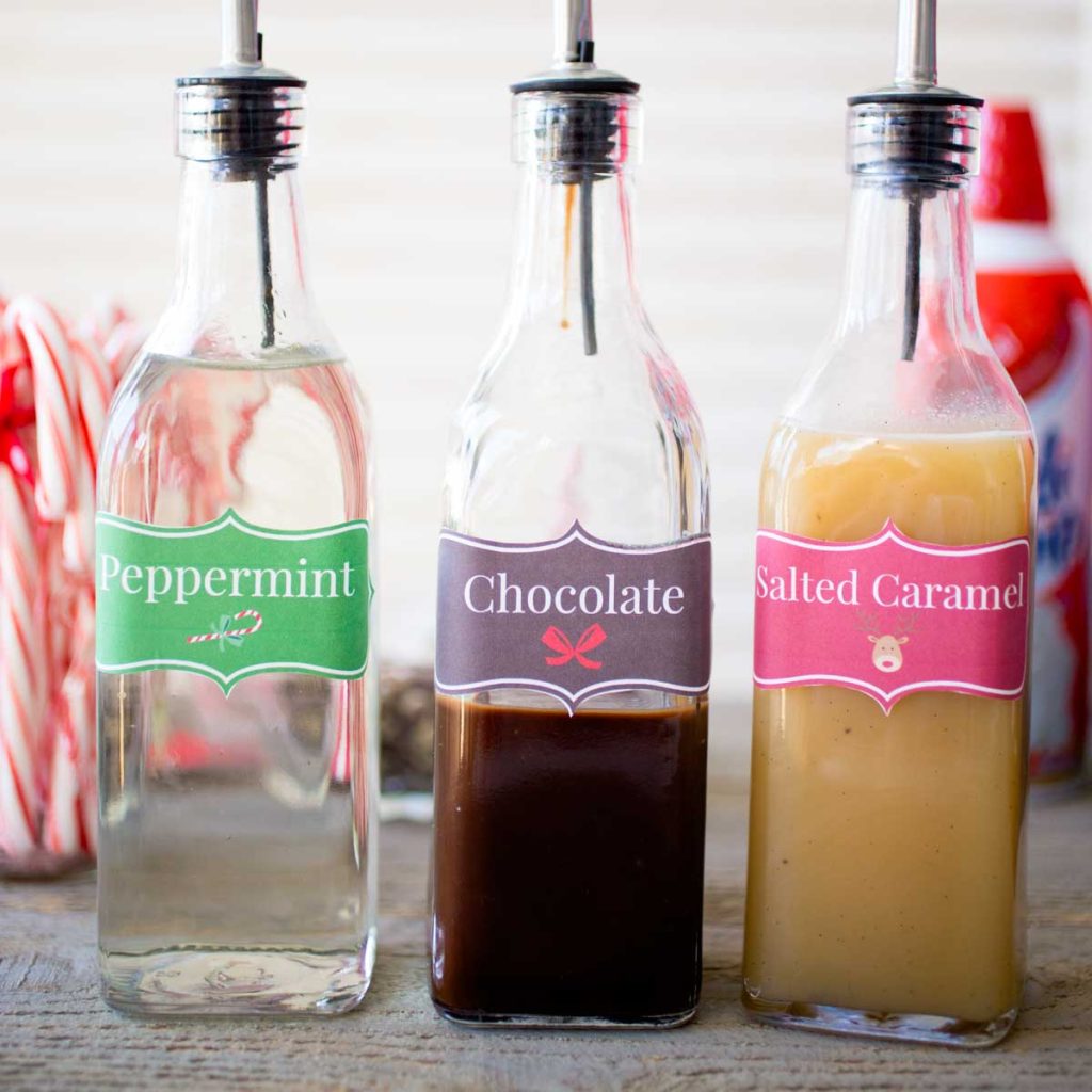 A row of festive holiday coffee flavoring syrups.