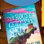 A copy of the book The House in the Cerulean Sea is on the table.