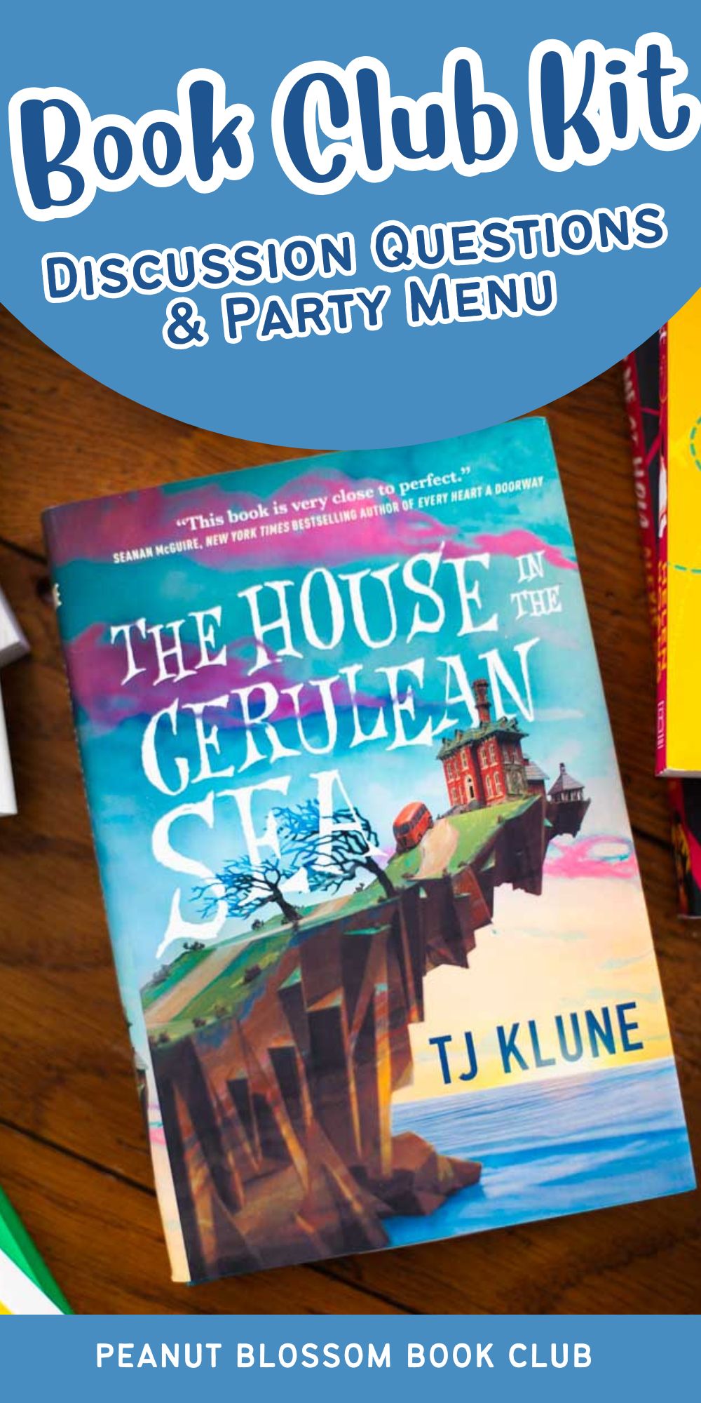 A copy of the book The House in the Cerulean Sea is on the table.