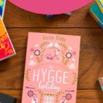 A copy of the book The Hygge Holiday sits on the table.