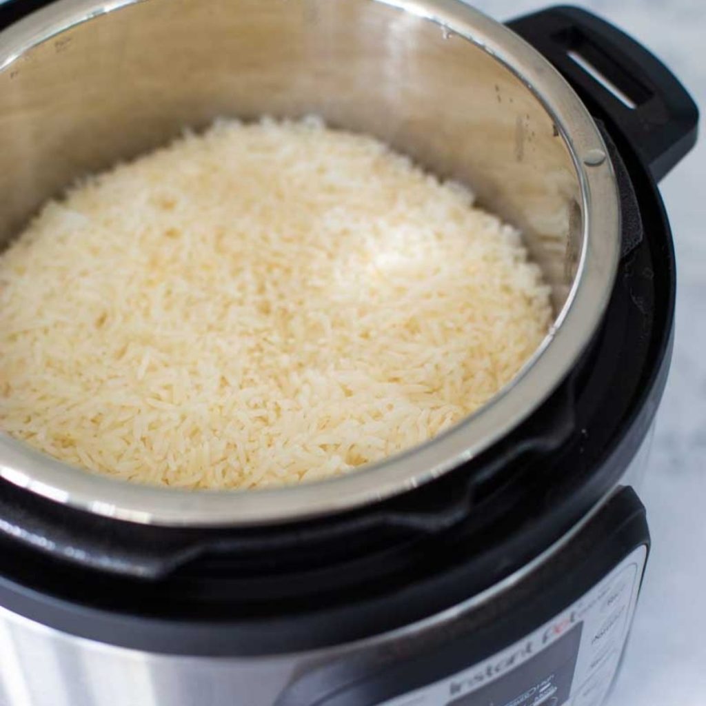 An Instant Pot is filled with cooked white rice.