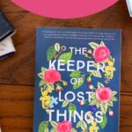 A copy of the book The Keeper of Lost Things is on the table.