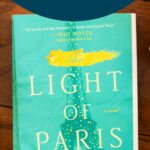 A copy of the book The Light of Paris sits on a table.