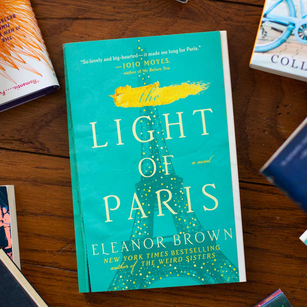 A copy of the book The Light of Paris sits on a table.