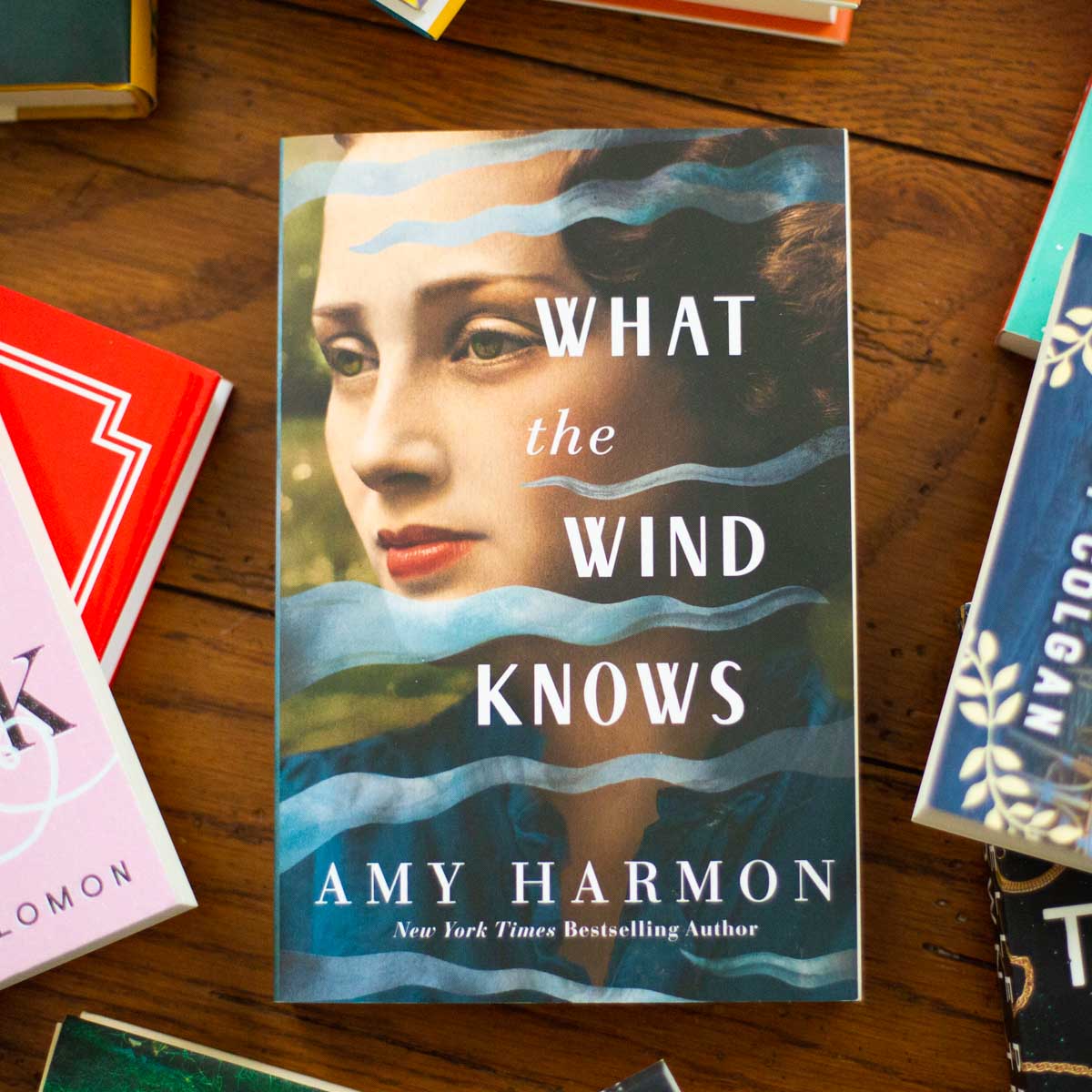 A copy of the book What the Wind Knows is on the table.