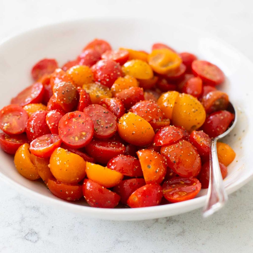 A bowl of sliced grape tomatoes