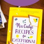 A copy of the book Miss Cecily's Recipes is on the table.