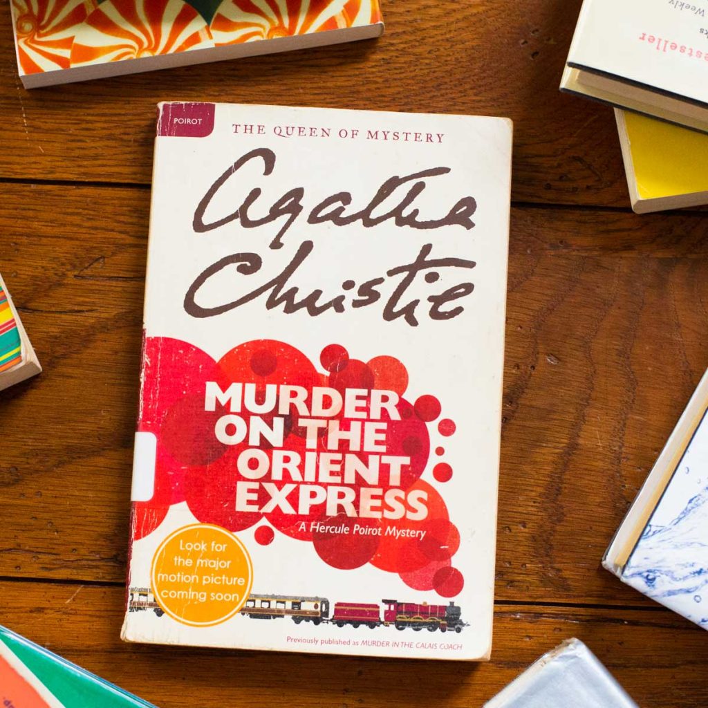 A copy of the book Murder on the Orient Express sits on a table.