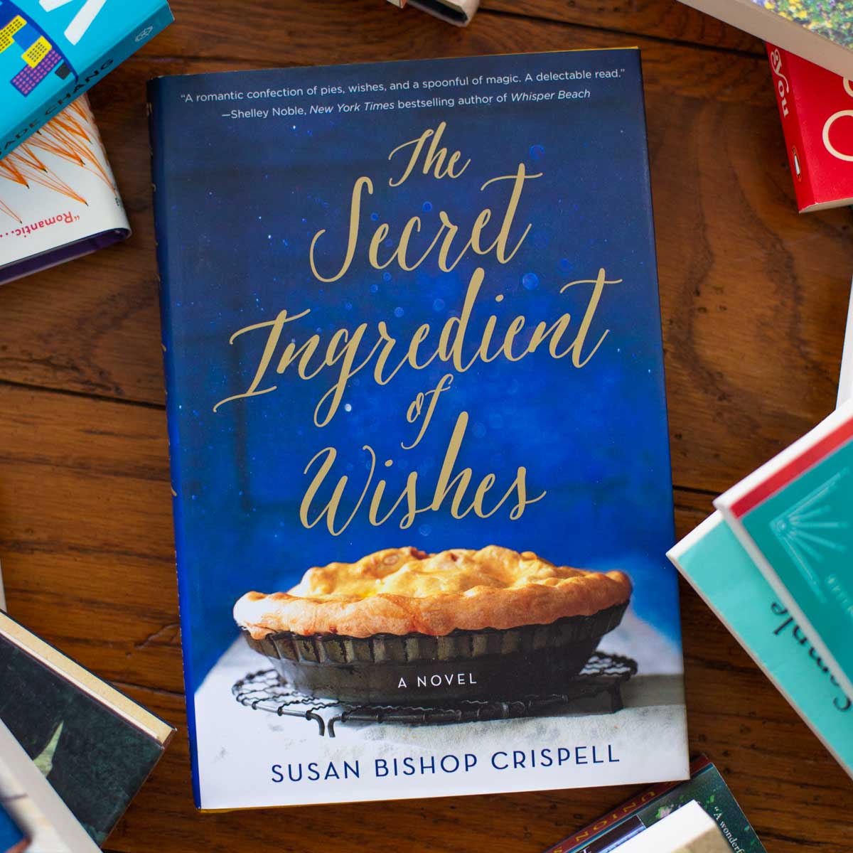 A copy of the book The Secret Ingredient of Wishes sits on a table.