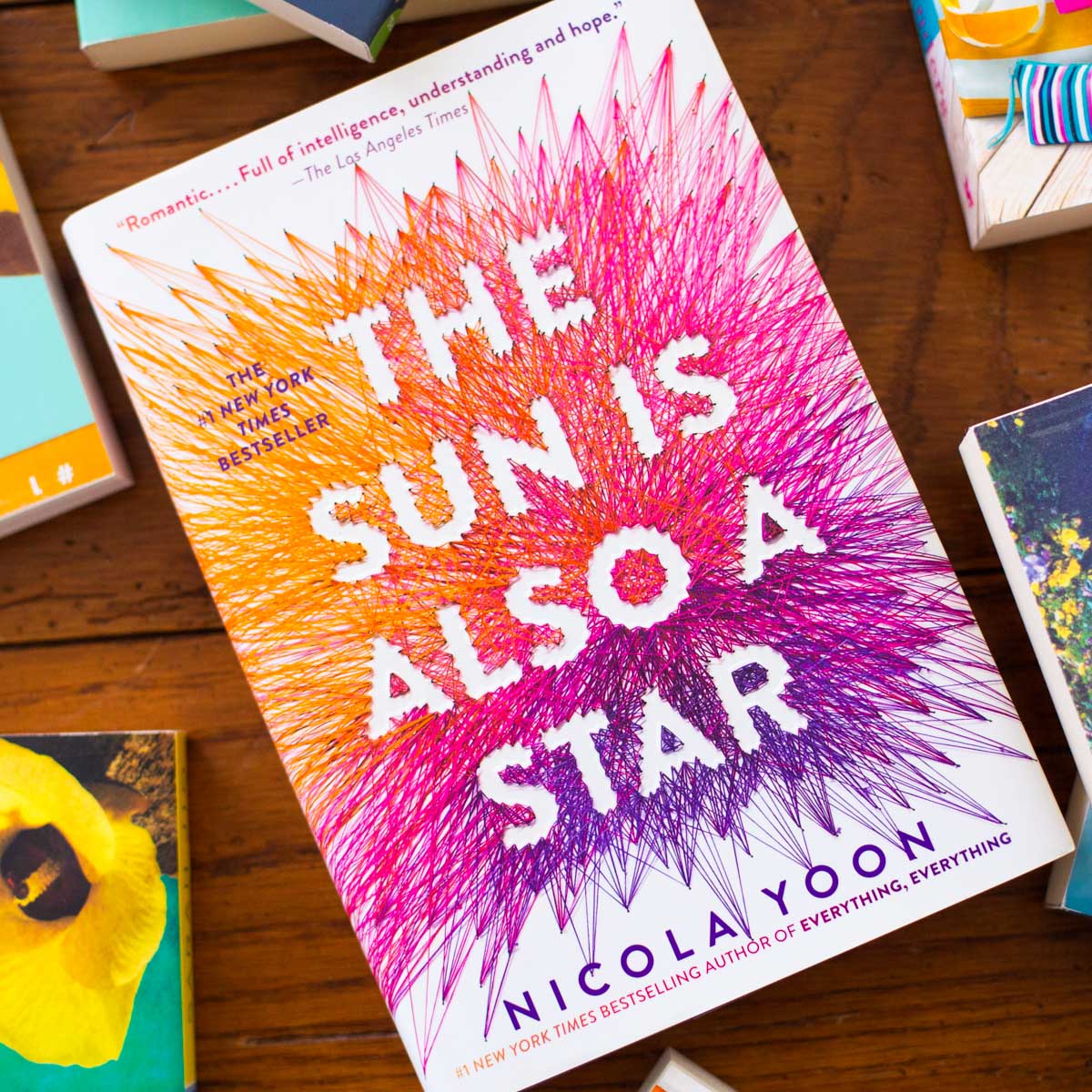 A copy of the book The Sun is Also a Star is on the table.