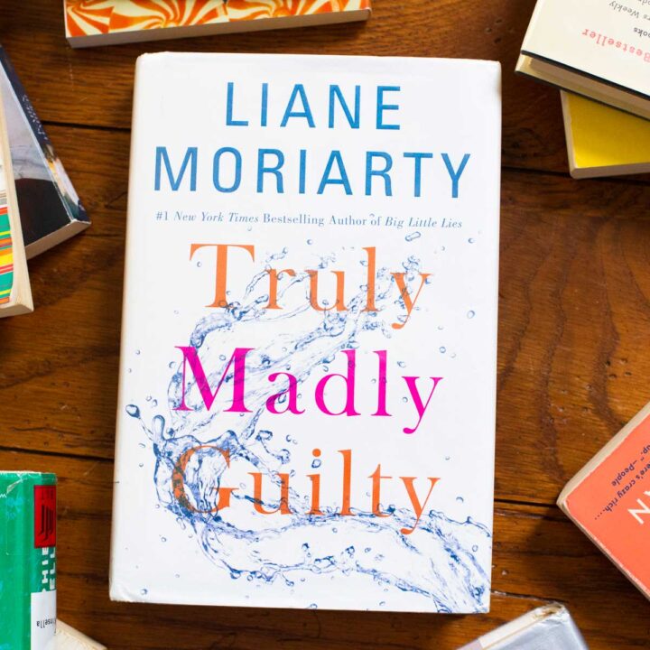 A copy of the book Truly Madly Guilty sits on the table.
