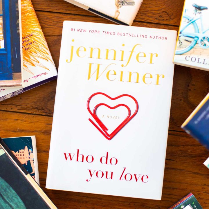 A copy of the book Who Do You Love by Jennifer Weiner is on a table.