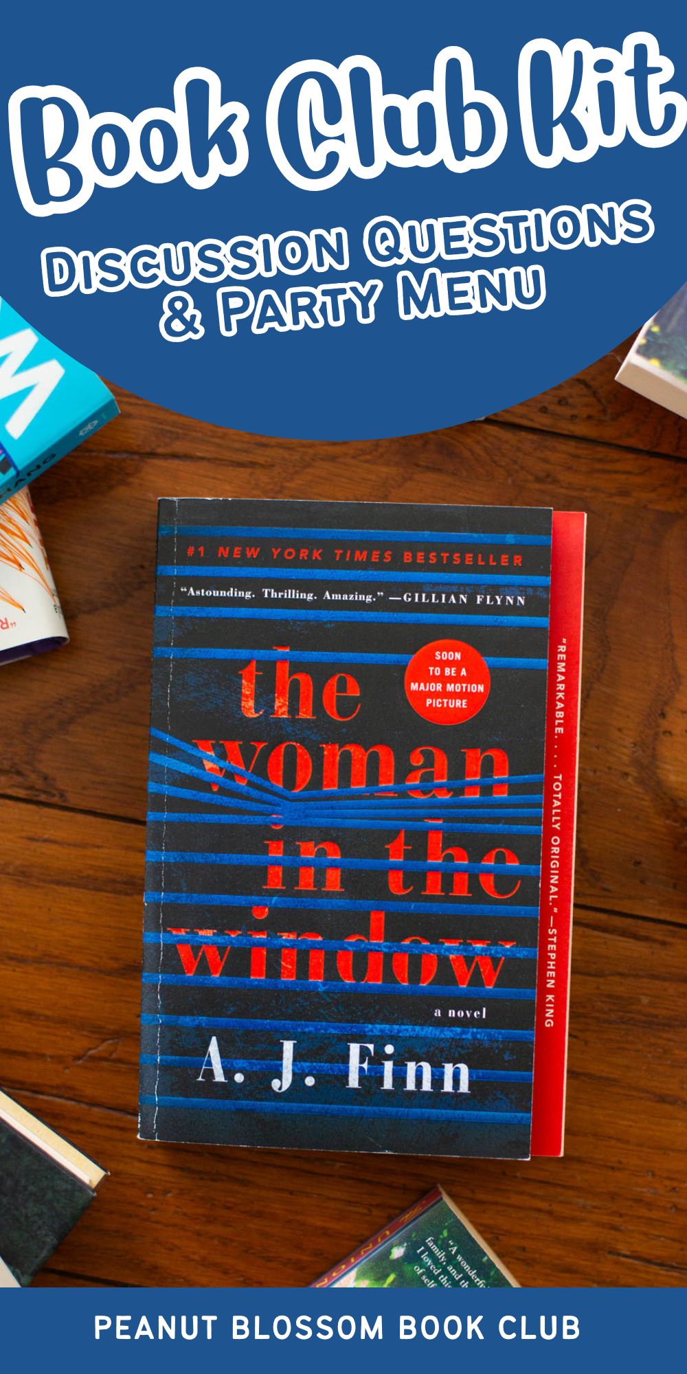 A copy of the book The Woman in the Window sits on a table.