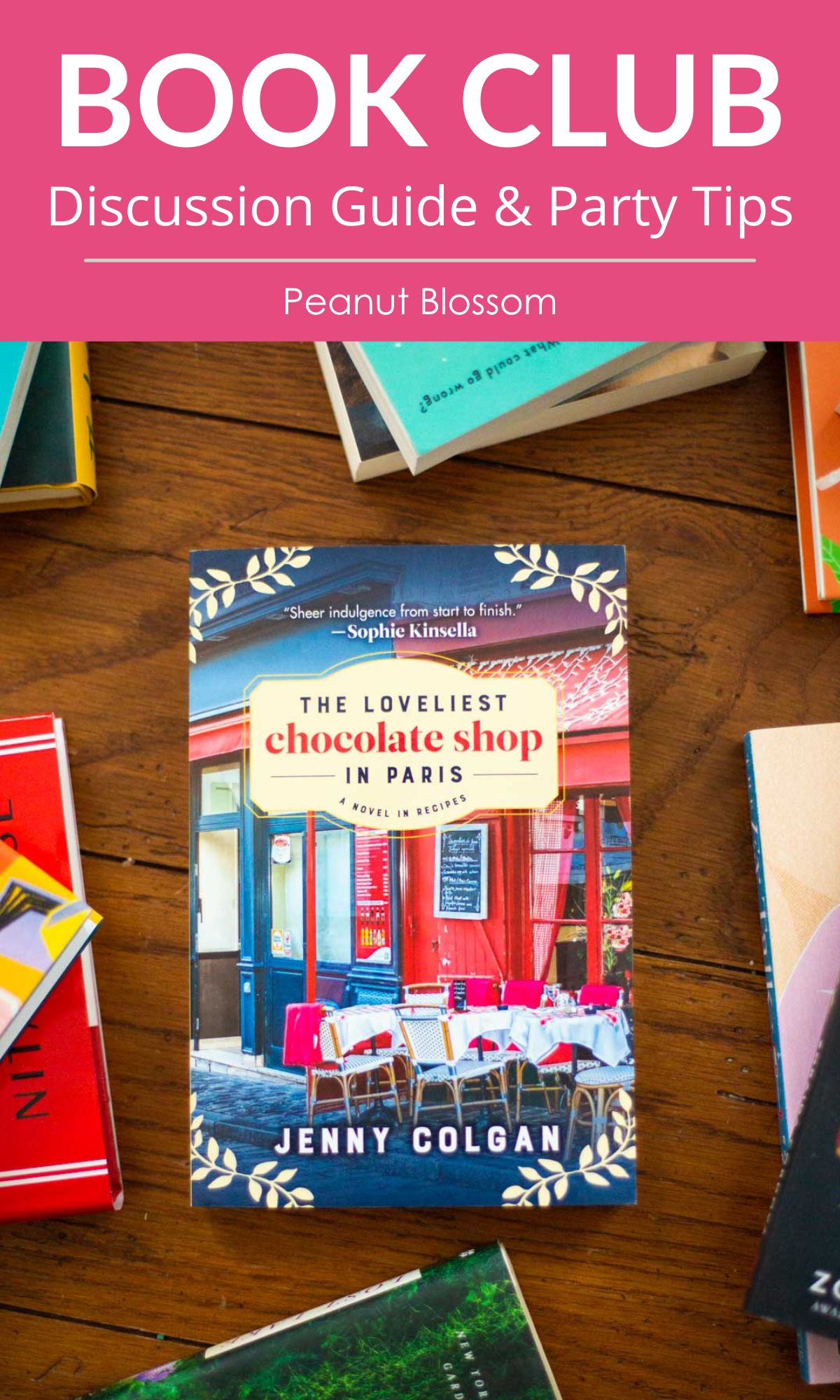 A copy of The Loveliest Chocolate Shop in Paris by Jenny Colgan sits on a table.