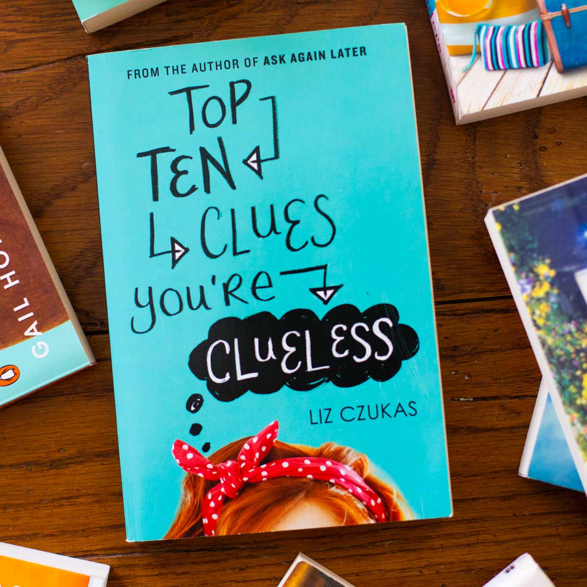 A copy of Top Ten Clues You're Clueless sits on a table.