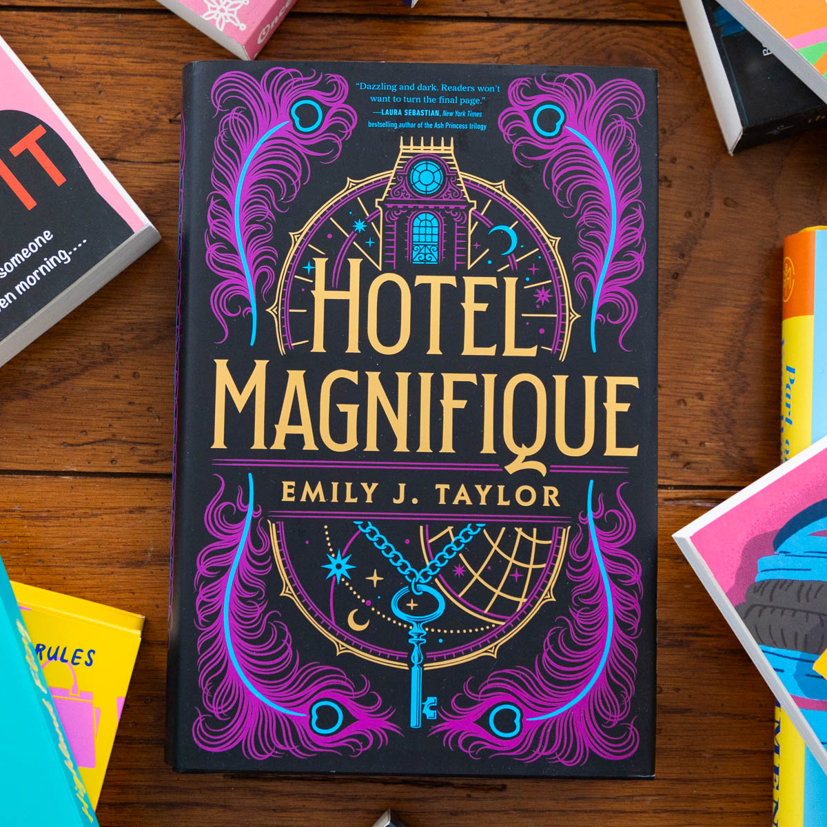 A copy of the book Hotel Magnifique is on the table.