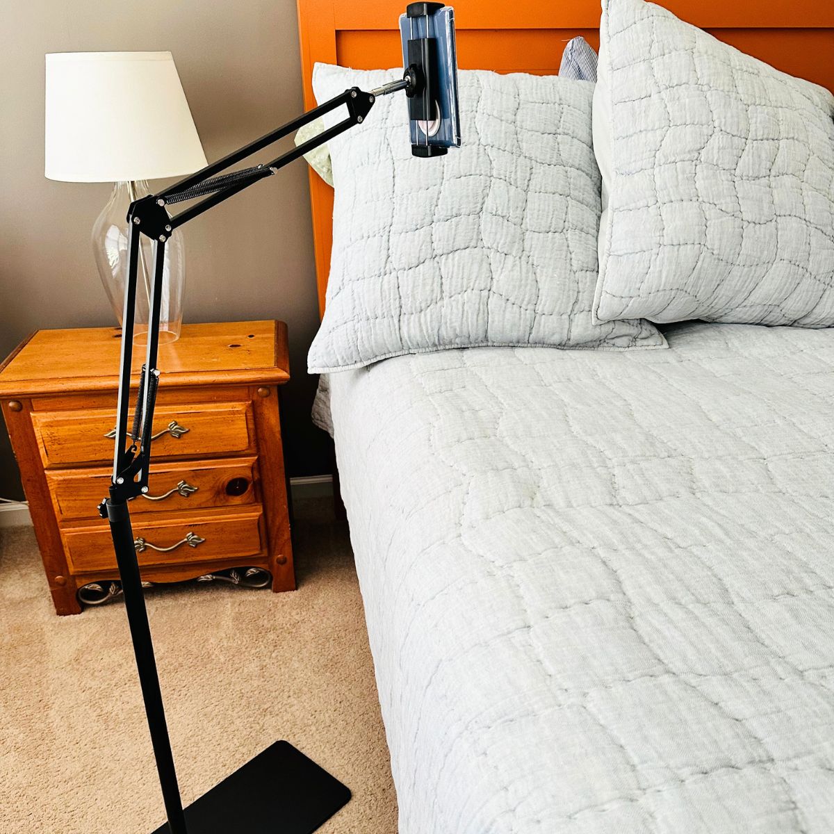 The Kindle stand has been set up next to the bed for cozy reading.