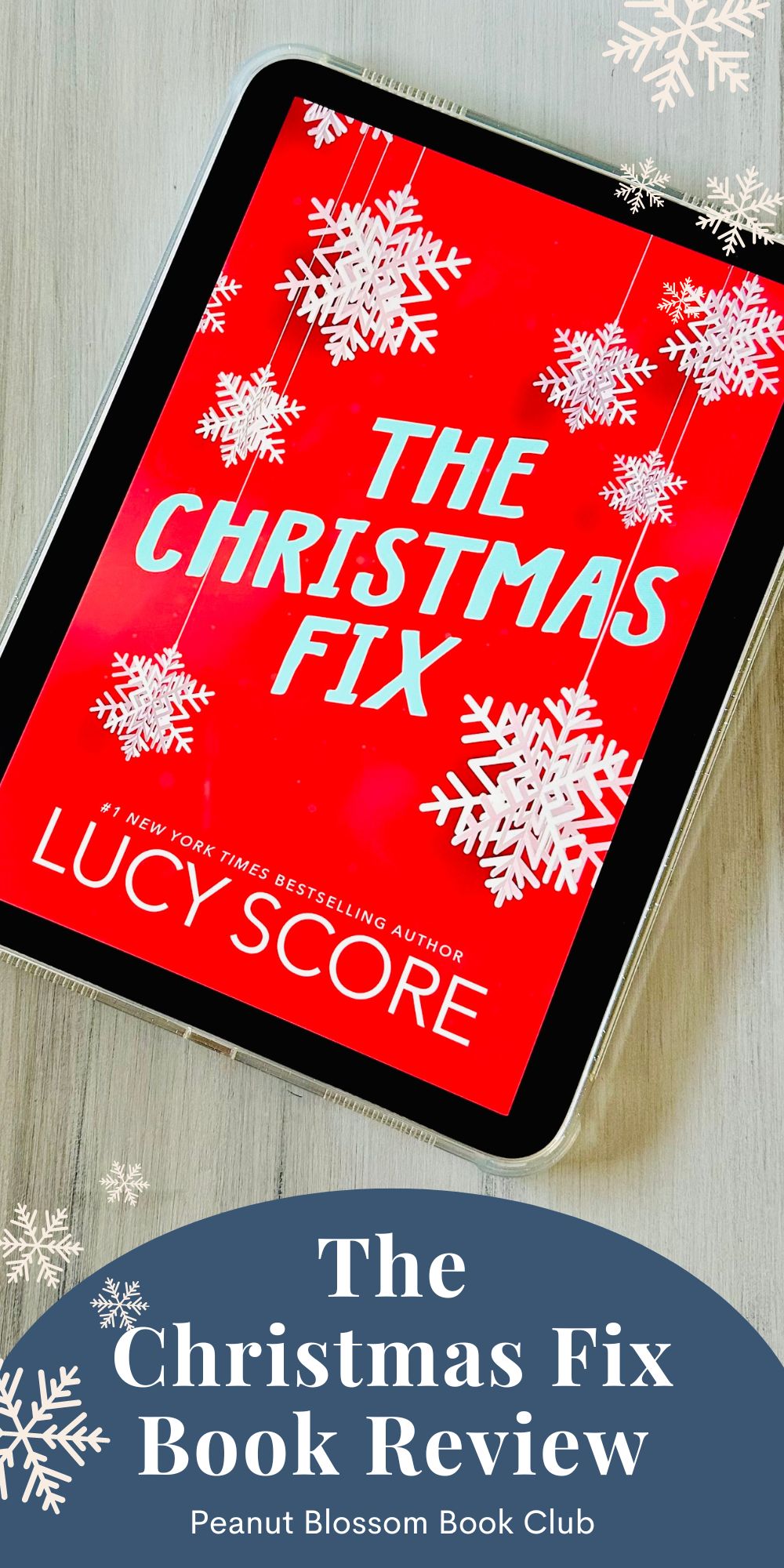 The cover of the book The Christmas Fix by Lucy Score is on the screen of an iPad.