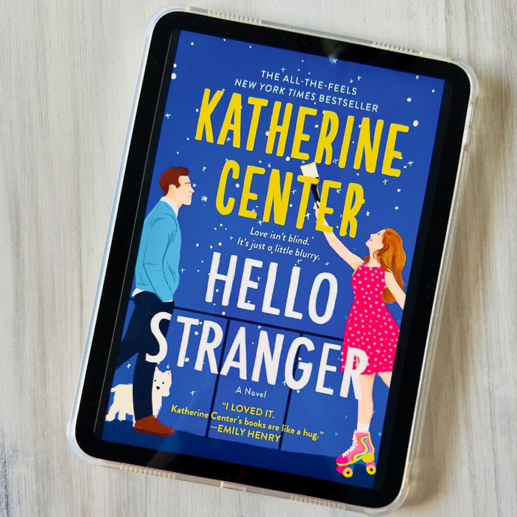 A copy of the book Hello Stranger by Katherine Center is on the screen of an ipad.