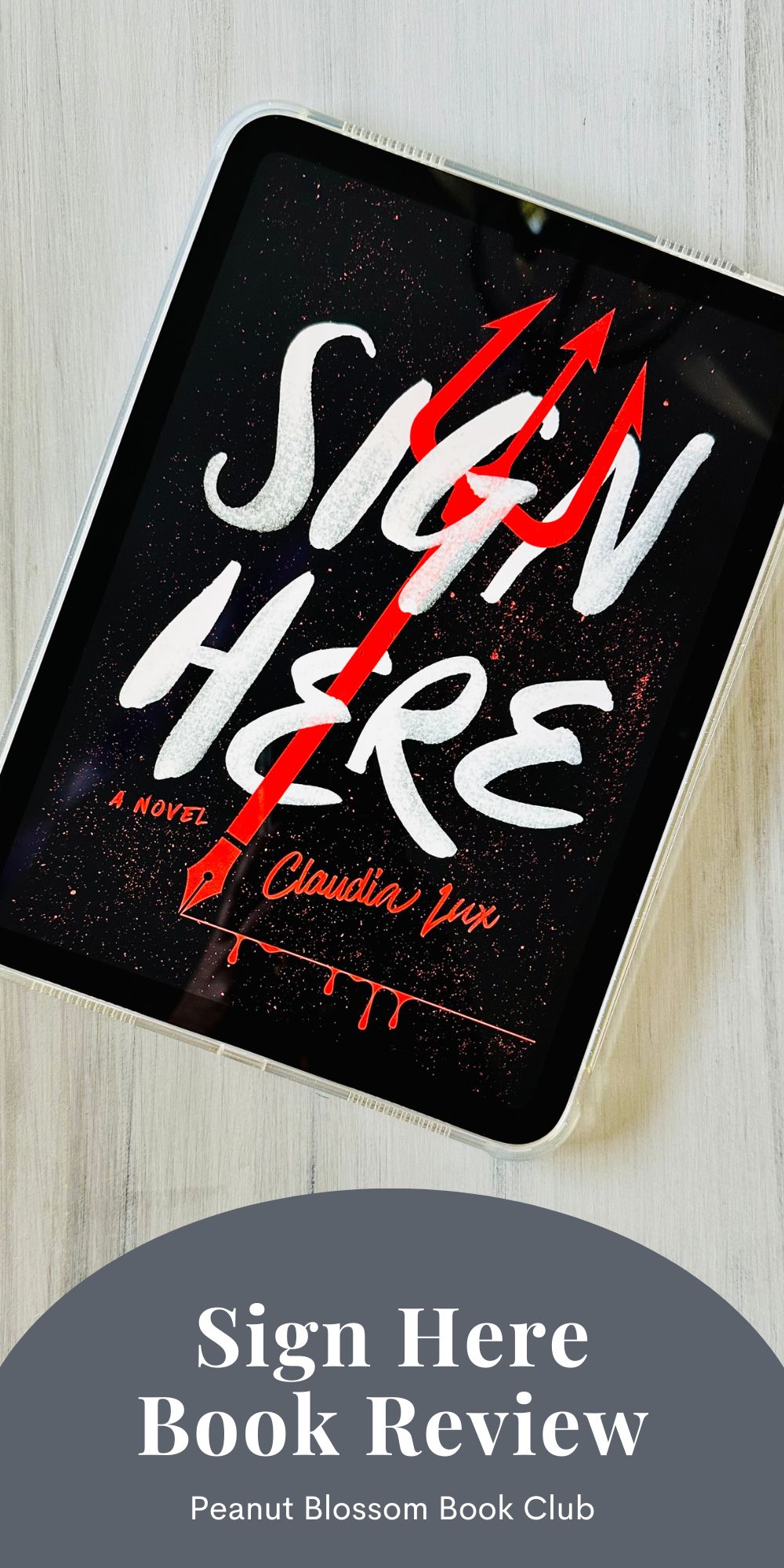 The cover of the book Sign Here by Claudia Lux is on the screen of an iPad.