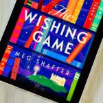 The cover of the book The Wishing Game by Meg Shaffer is on the screen of an iPad.