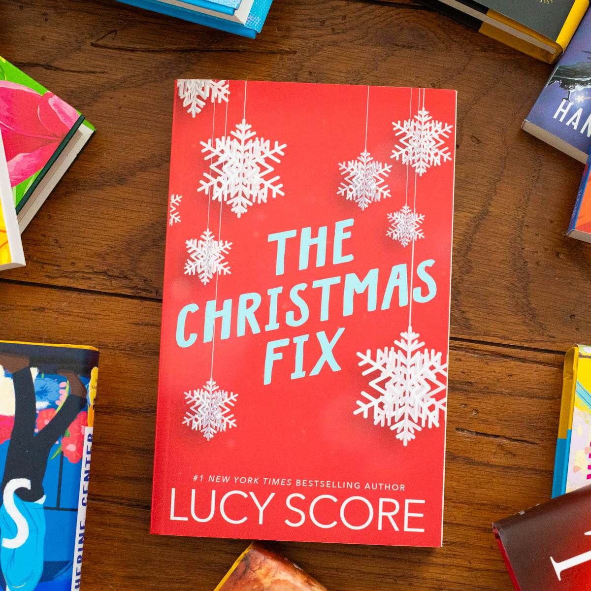A copy of the book The Christmas Fix by Lucy Score sits on the table.