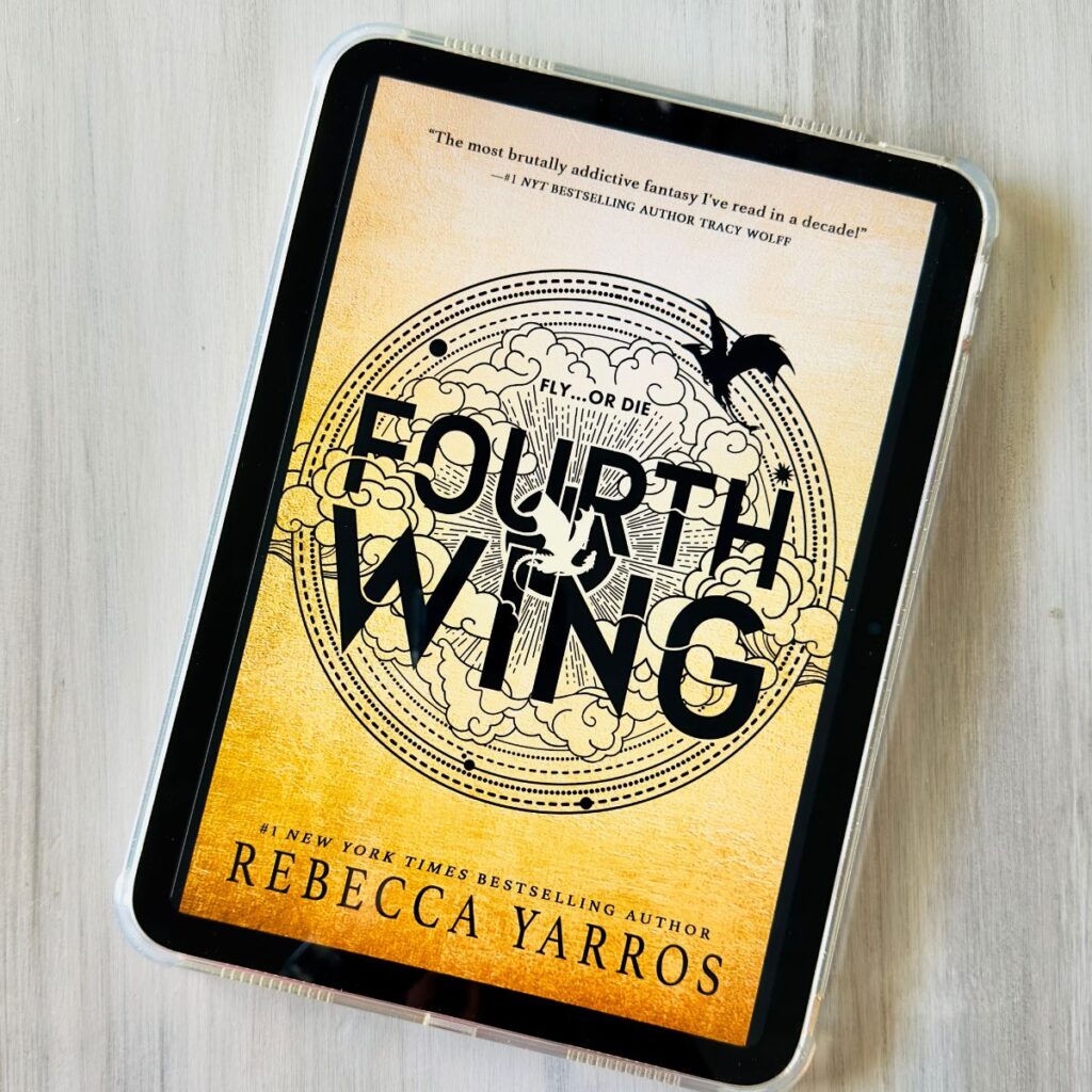 A copy of the book Fourth Wing by Rebecca Yarros is on the screen of an iPad.