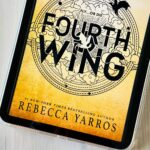 A copy of the book Fourth Wing by Rebecca Yarros is on the screen of an iPad.